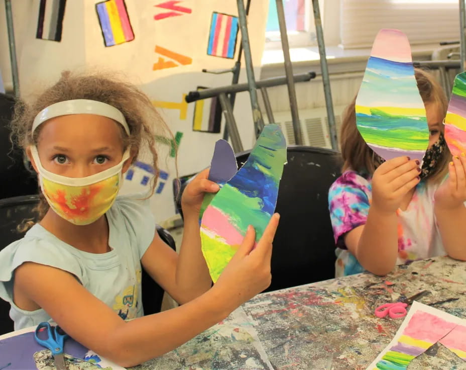 a couple of kids wearing party hats