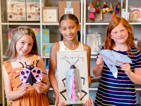 a group of girls holding a sign