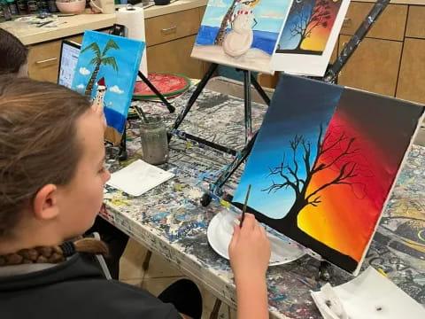 a boy painting on a table