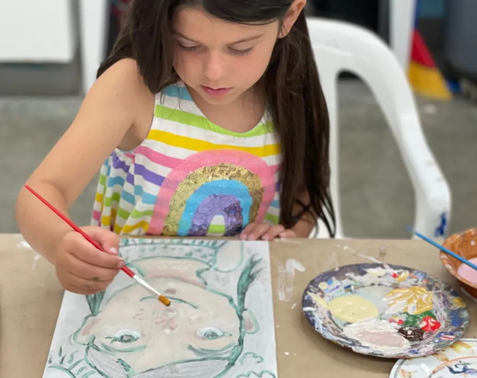 a girl painting on a table