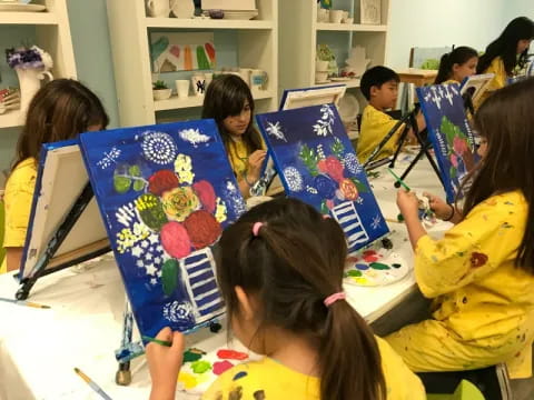 a group of children holding up colorful cards