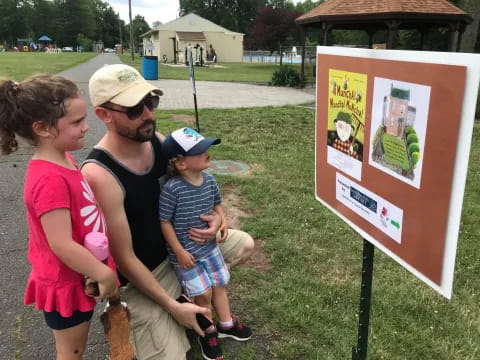 a man and woman looking at a sign