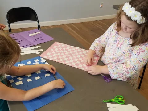 a few young girls doing crafts