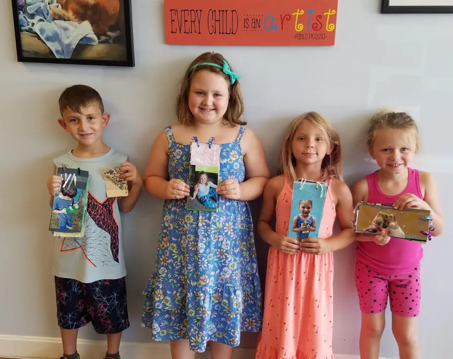 a group of children holding a cake