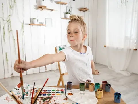 a girl painting on a table