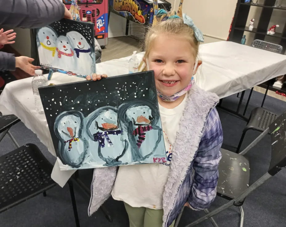 a girl holding a cake
