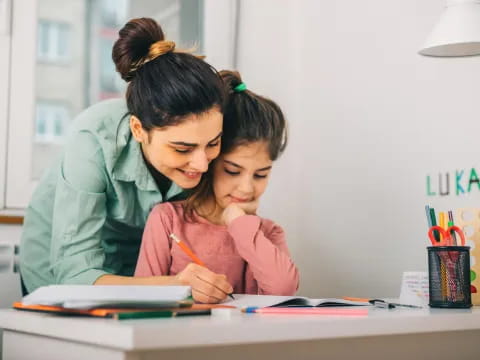 a woman and a girl studying