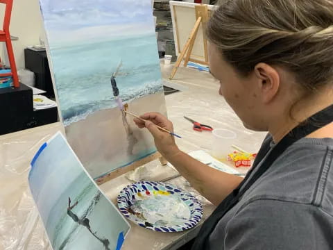 a person painting on a table