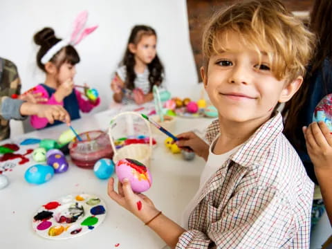 a young boy holding a cupcake