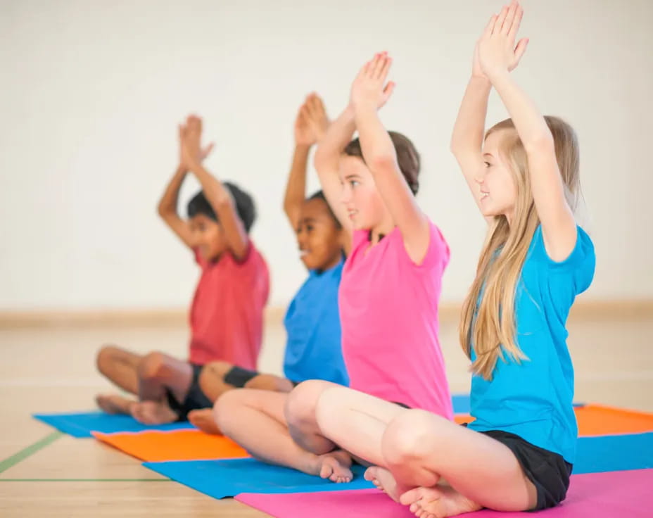 a group of children raising their hands