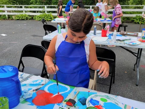 a girl painting on a table