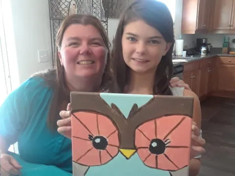 a couple of girls holding a sign