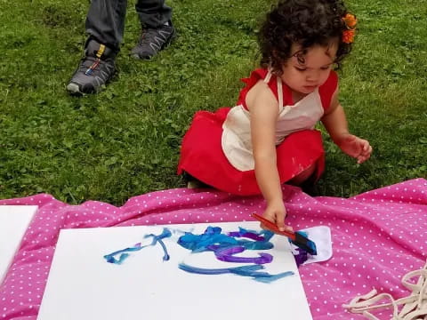 a child sitting on the grass