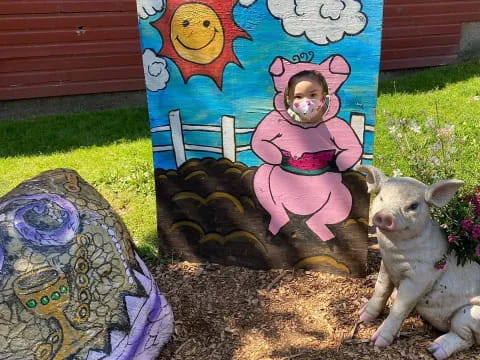 a dog sitting next to a painting
