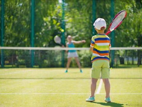 a kid playing tennis
