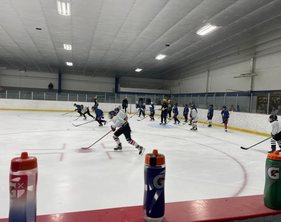 a group of people playing hockey