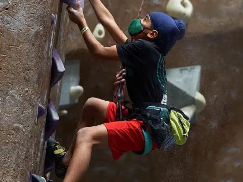 a man climbing a rock wall