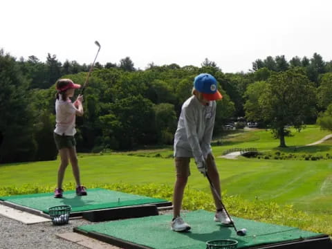 a couple of people playing golf