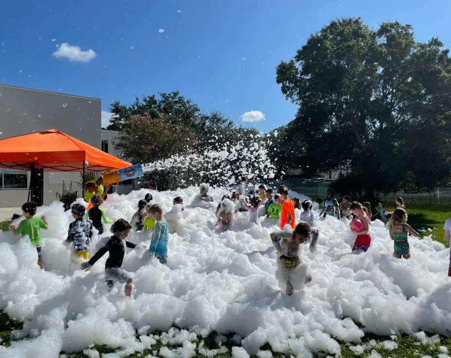 a group of people playing in a field of white flowers