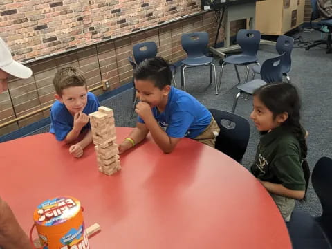 a group of people sitting around a table