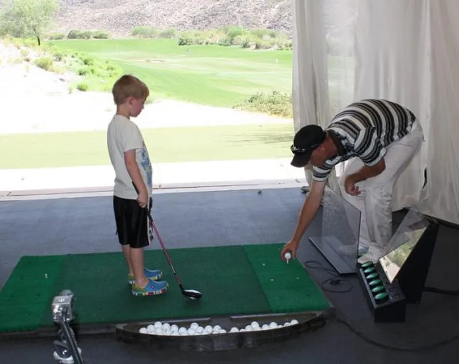 a man and a boy playing golf