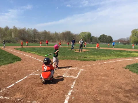 a kid swinging a baseball bat