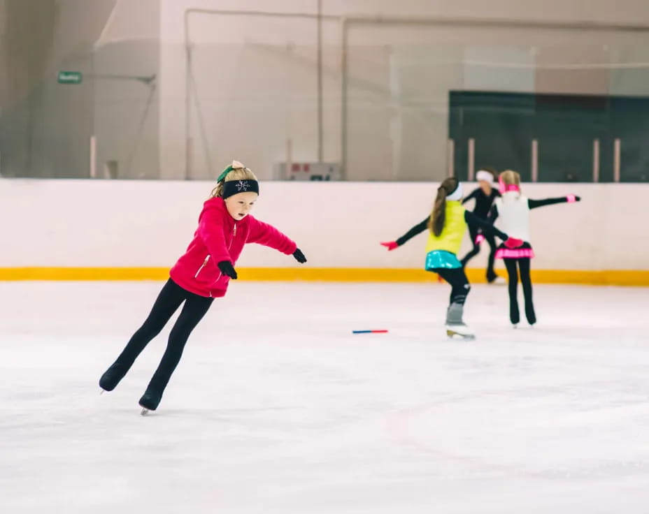 a group of women ice skating