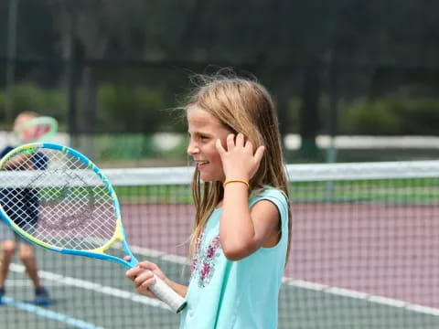 a girl holding a tennis racket