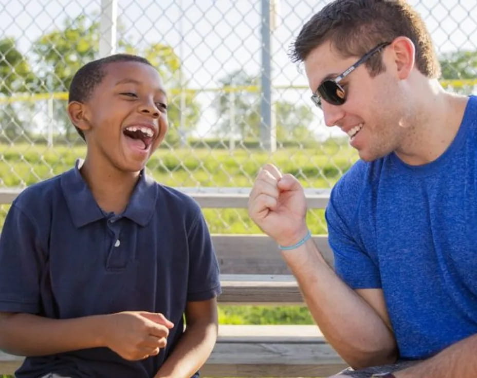 a group of men sitting on a bench