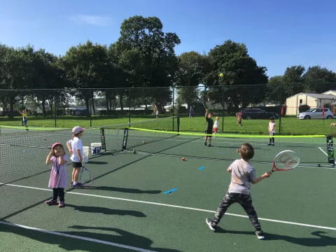 kids playing tennis on a court