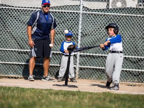a kid holding a baseball bat