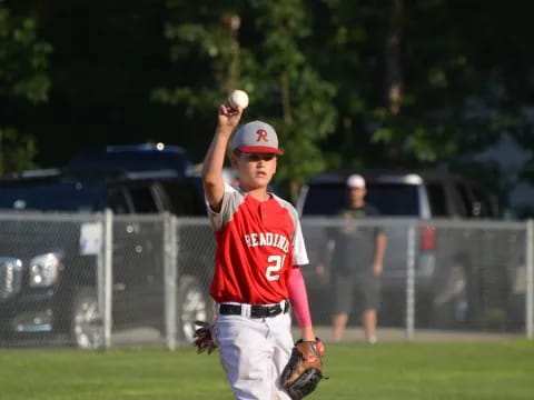 a kid throwing a baseball