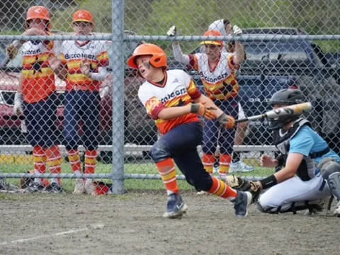 a person swinging a baseball bat