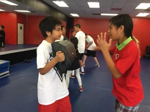 a person and a boy in a gym