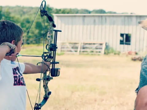 a person shooting a bow and arrow