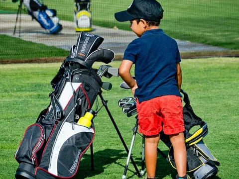 a boy with a golf club