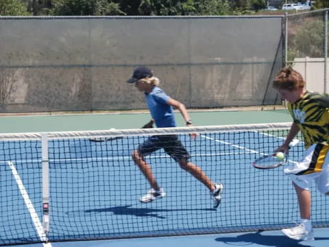 a couple of men playing tennis