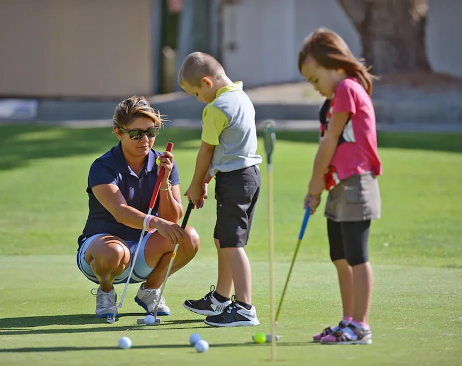 a group of kids playing golf