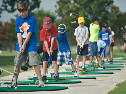 a group of kids playing mini golf