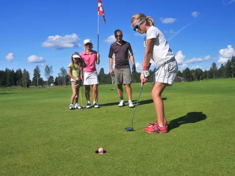 a group of people playing golf