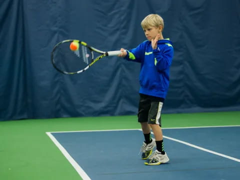 a boy playing tennis