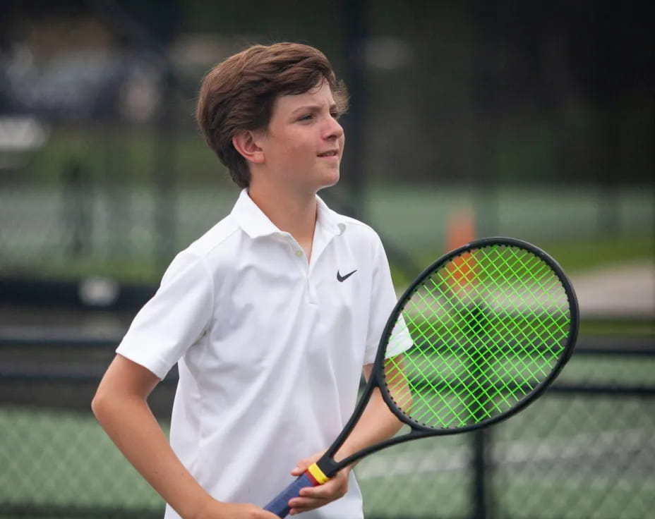 a man holding a tennis racket