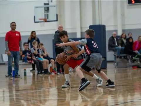 a couple of boys playing basketball