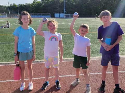 a group of kids holding cups