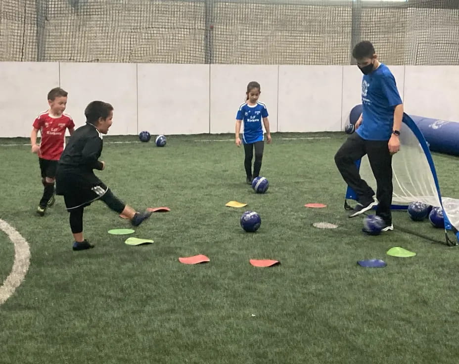 a group of kids playing football