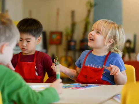 a few children sitting at a table