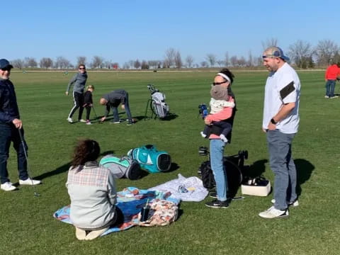 a group of people standing on a field with backpacks