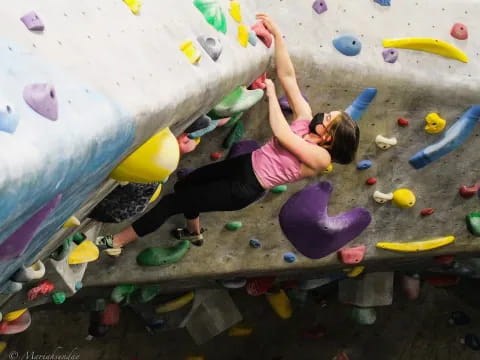 a girl climbing a rock wall