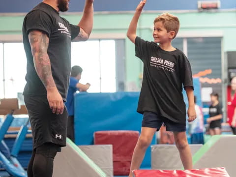 a man and a boy in a gym