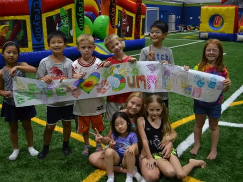 a group of kids holding a sign